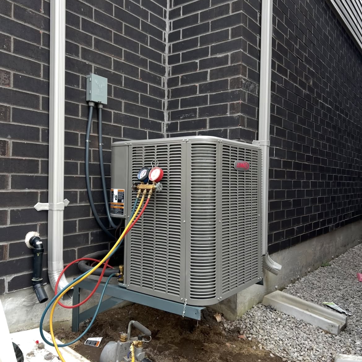 Outdoor air conditioning unit with service gauges attached