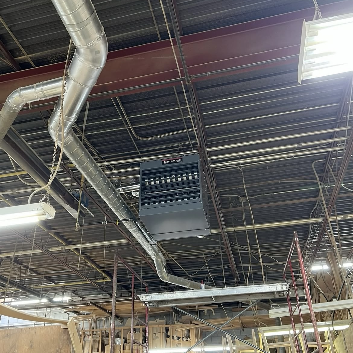 Commercial ductwork and ceiling-mounted heating unit