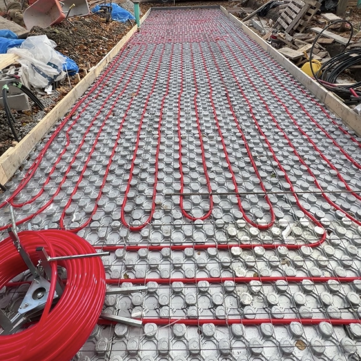 Radiant floor heating tubing installed before concrete pour